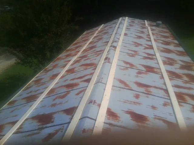 Rusted metal roof panels with new wood purlins before replacement — Storm Damage Roof Repair in Smartsville by Roofing Brothers