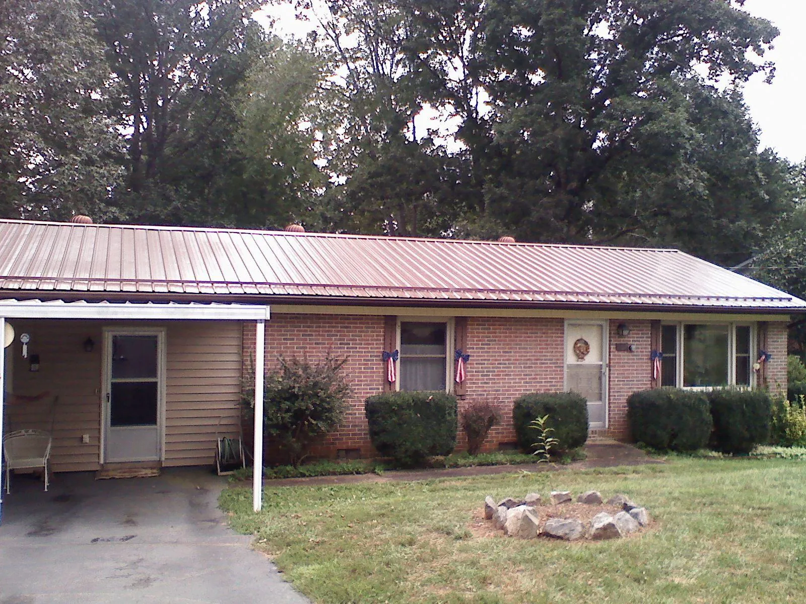 Bronze metal roof and carport on a brick ranch home — Roof Repair work by our crew in Smartsville